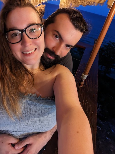 Ariele & Stephen posing for a selfie in Puerto Rico with the Atlantic Ocean in the background
